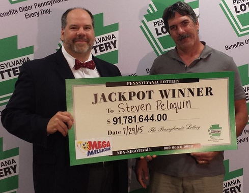 Lottery Executive Director Drew Svitko presented a ceremonial check for $91,781,644.00 to Mr. Steven Peloquin,